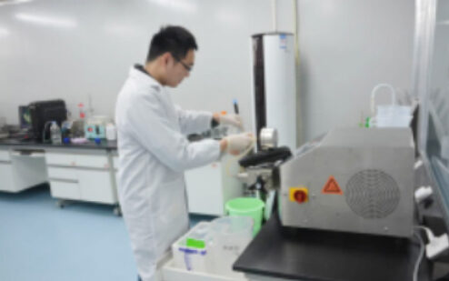 Technician operating equipment at a lab bench