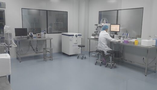 Molecular laboratory with instruments and a technician at a workstation